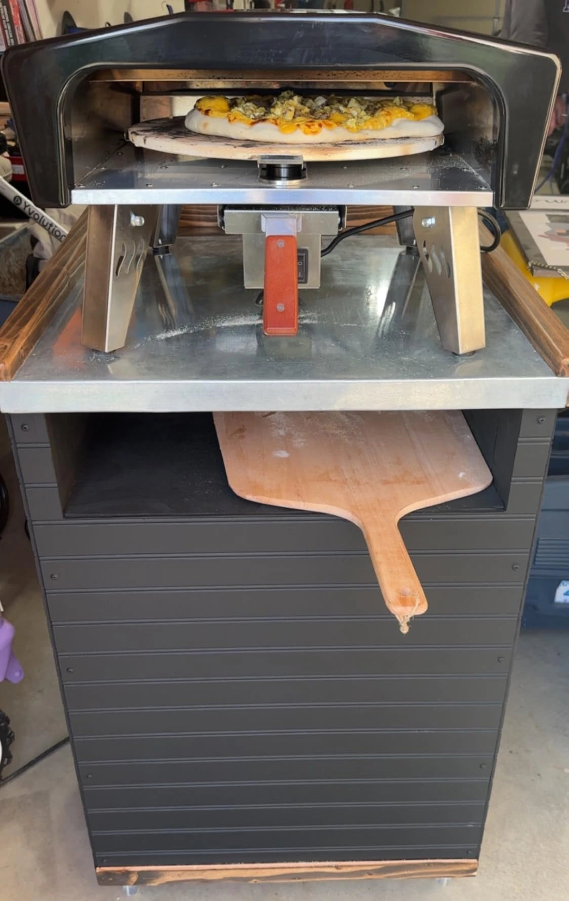 SizzleDelite Firo 14 pizza oven baking pizza in a garage setup