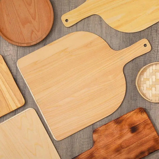 SizzleDelite Wooden Pizza Peel with Handle – Top View on Wood Background among Other Pizza Boards